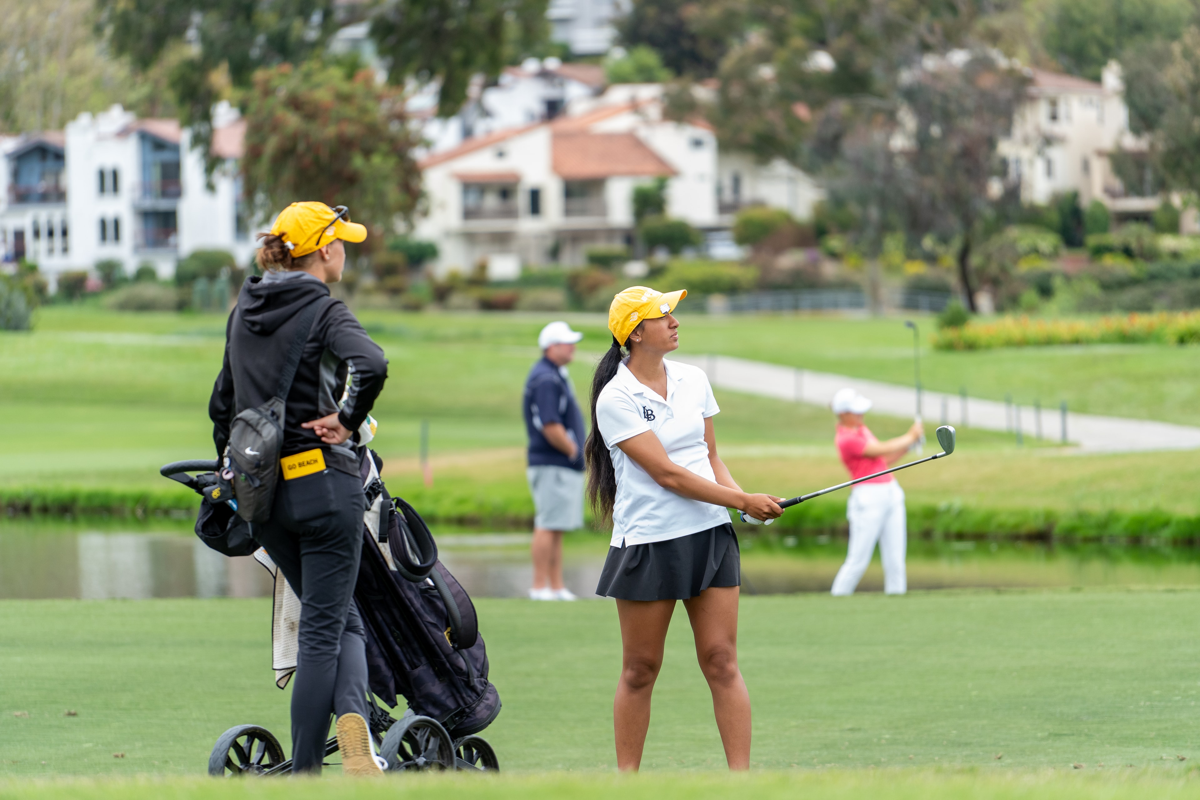 Golfer on the course with caddy